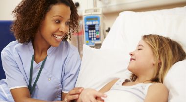 Nurse with young child patient in hospital